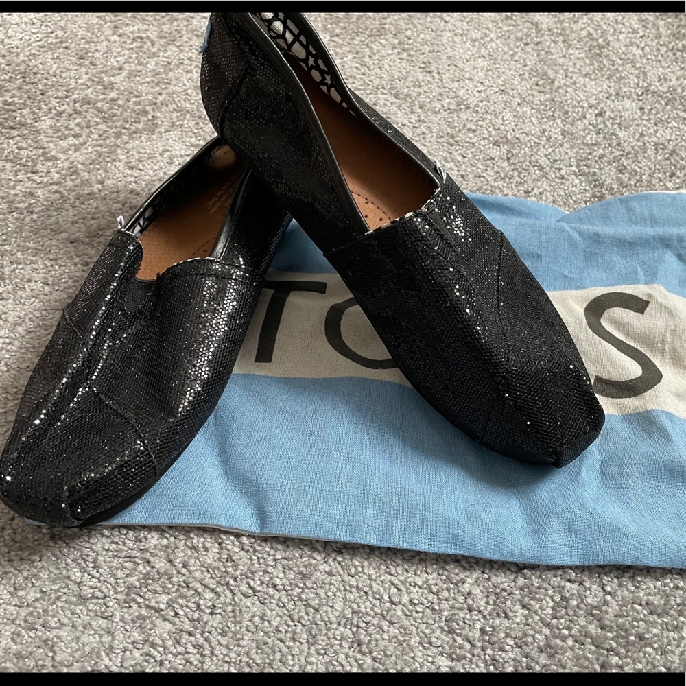 Tom’s black shiny slip ons